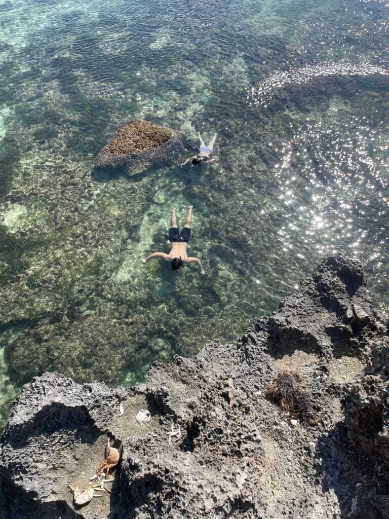 Birds eye view of two people snorkelling at Suluban Beach Bali