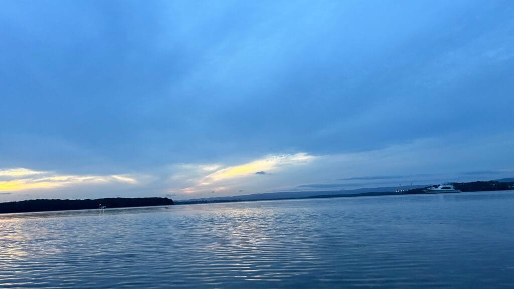 sunsetting over Lake Macquarie, clouds cover the sun