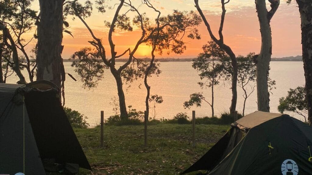 Two tents overlooking Lake Macquarie at Wangi Point Holiday Park as the sun rises